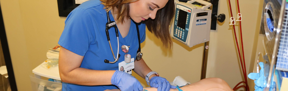 Student working on a dummy patient