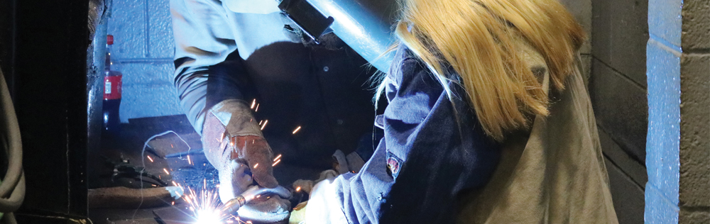 photo of students welding