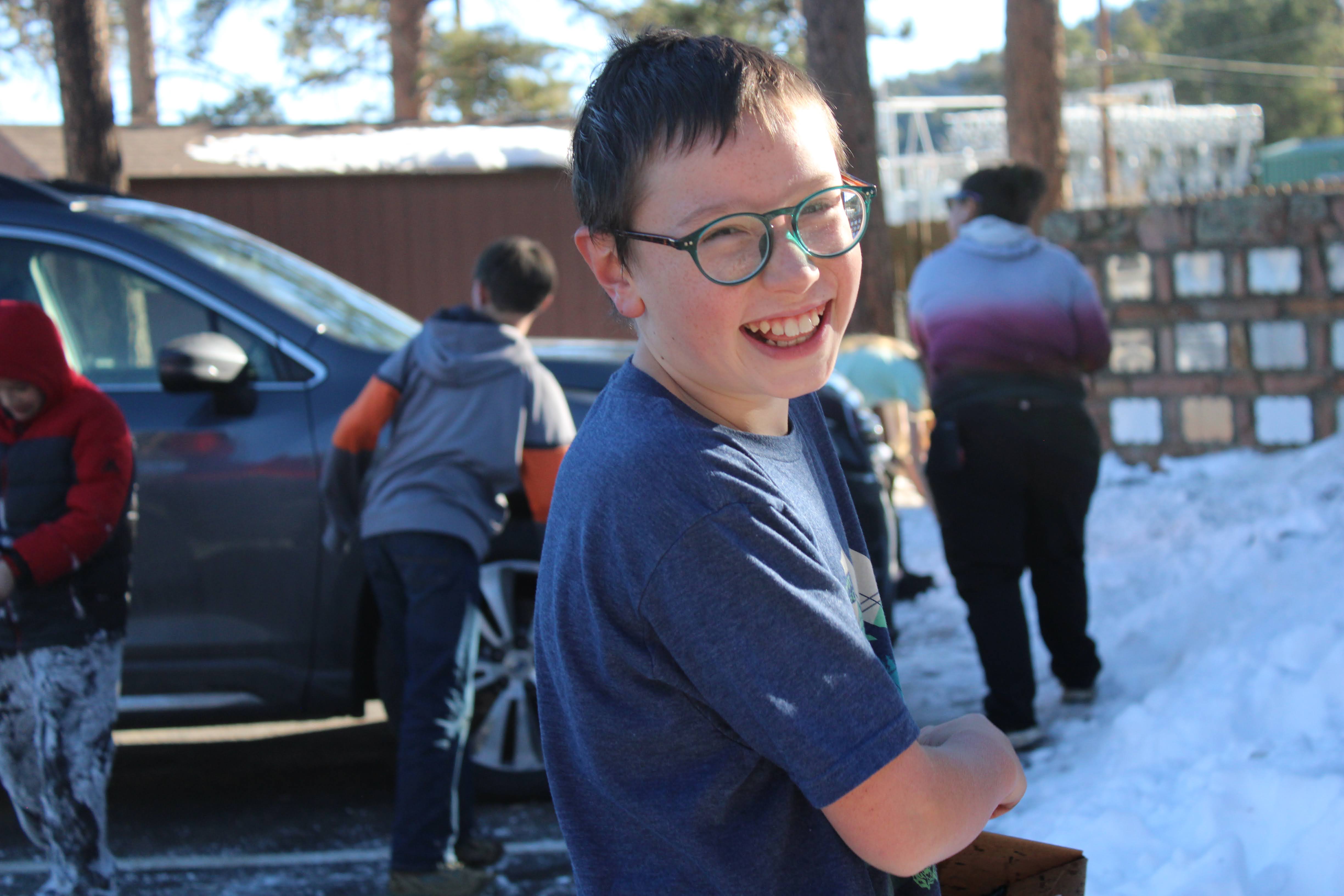 Student standing in parking lot smiling 