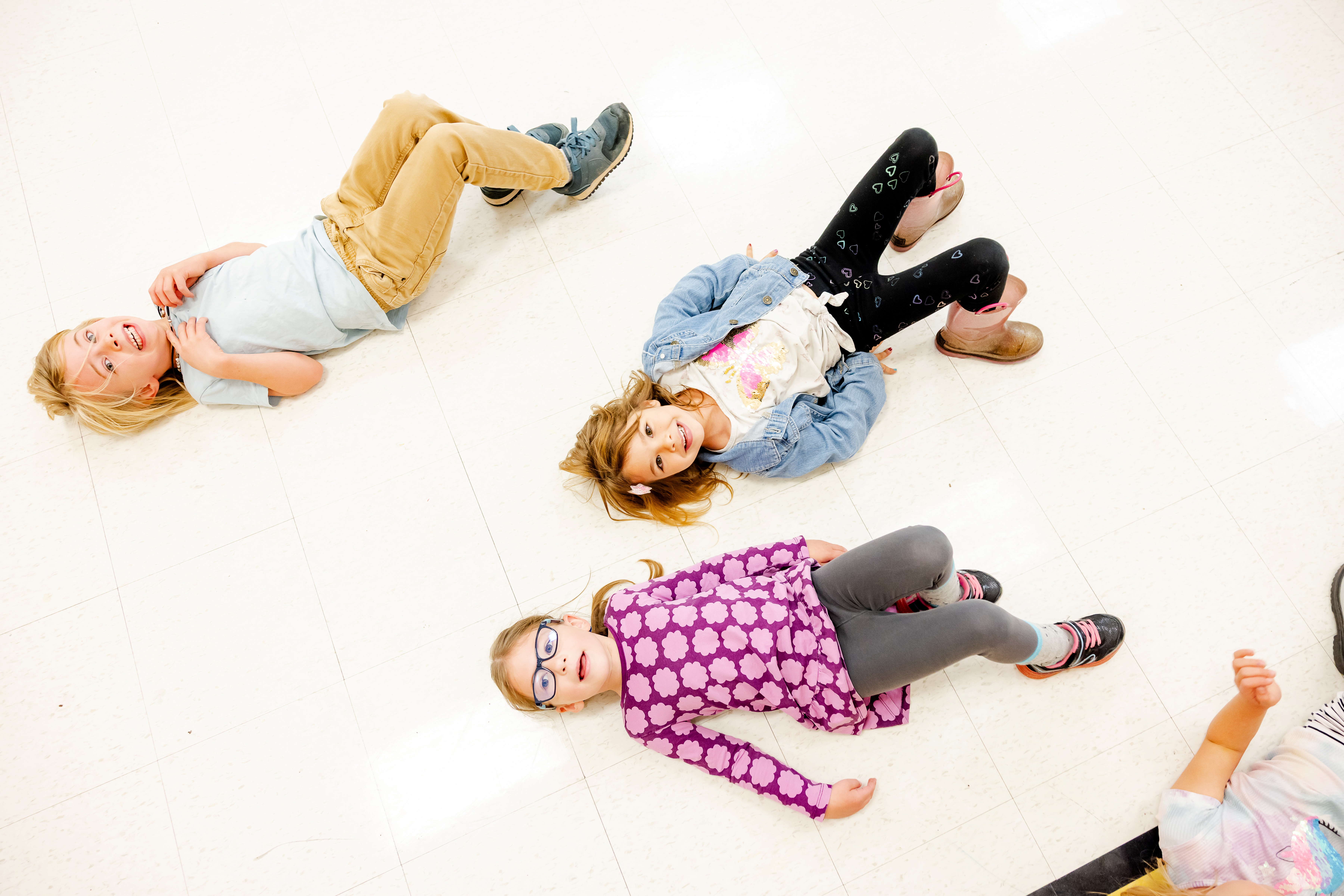 Students laying on gym floor