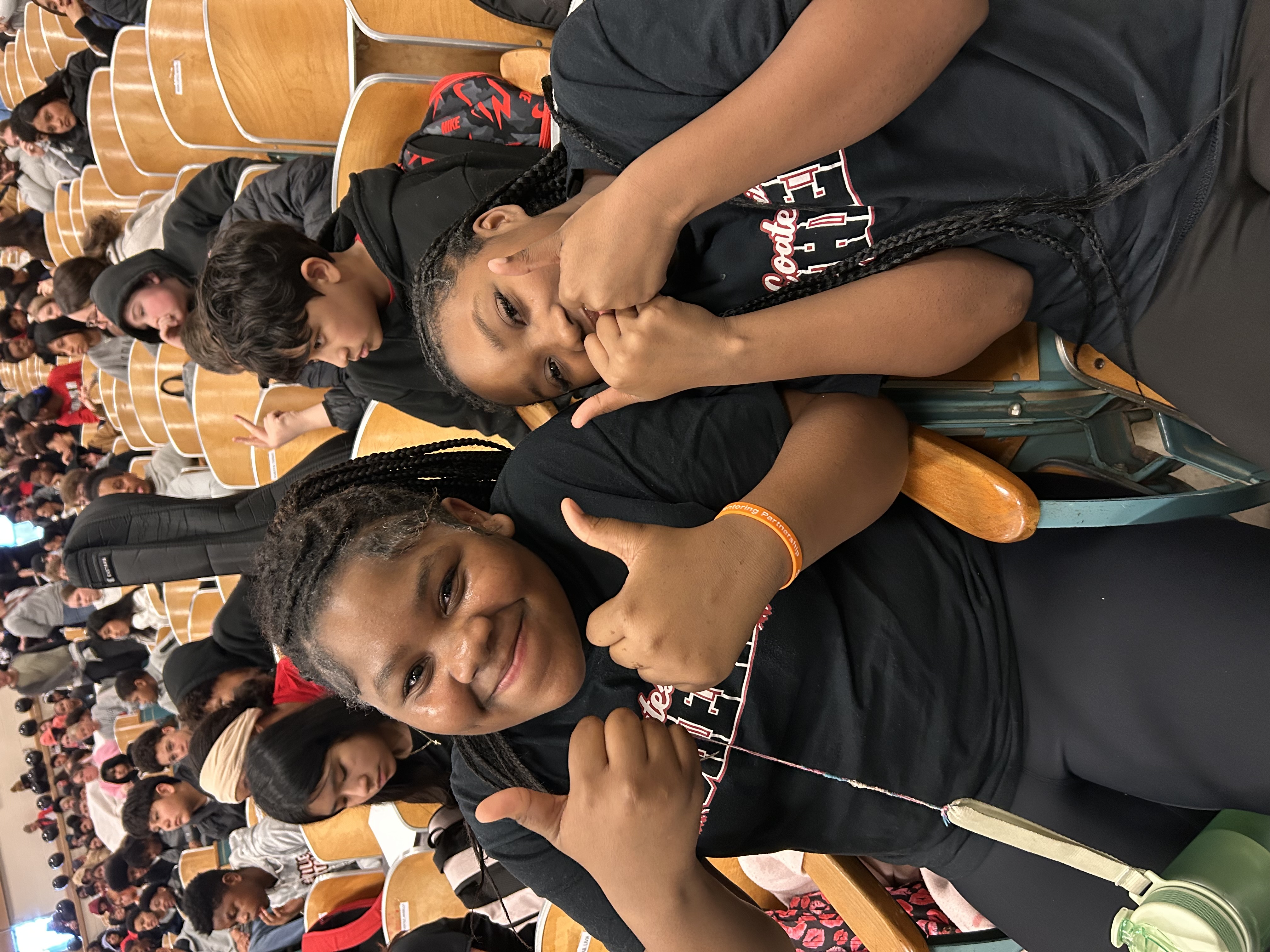 two smiling cheerleaders giving thumbs up