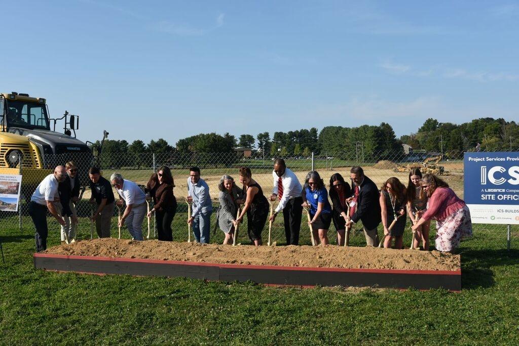 groundbreaking ceremony for new building 10 people pose for the pic with golden shovels