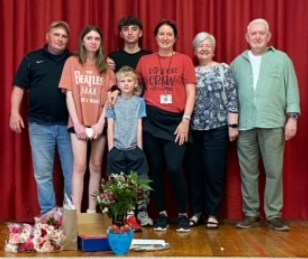  A group of people standing in front of a red curtain