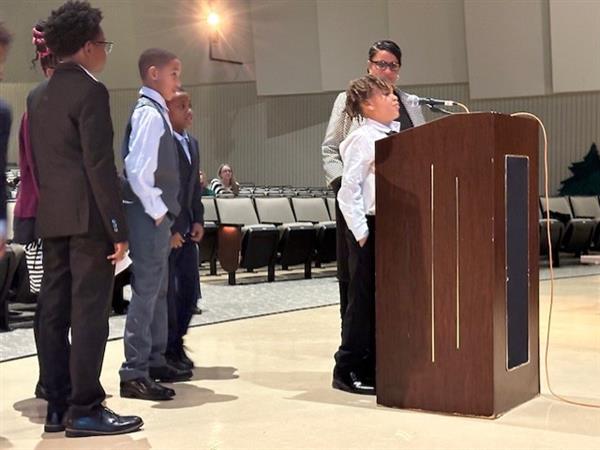 People gathered around a podium for a speech.