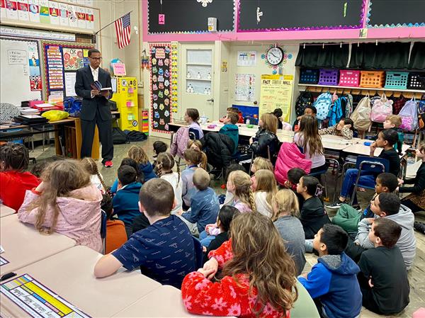 A man teaching children in a classroom.