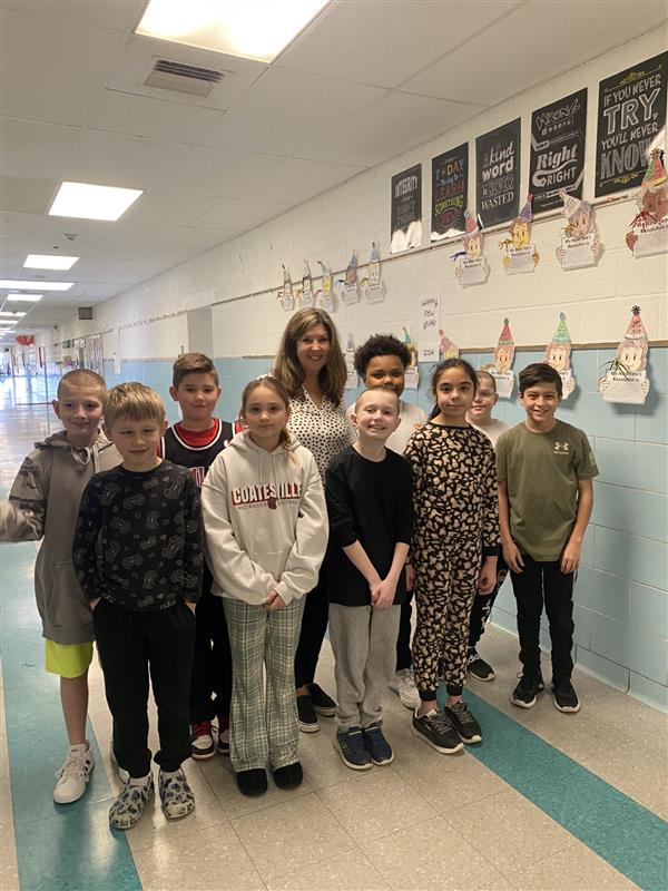 A group of children standing in a hallway.