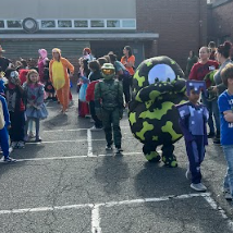 Kids in costumes standing in a row.