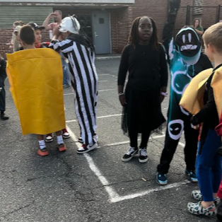 Kids in costumes standing in a row.