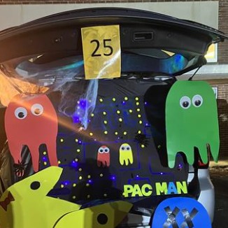 Car covered in Pac-Man and other characters, colorful and fun design.