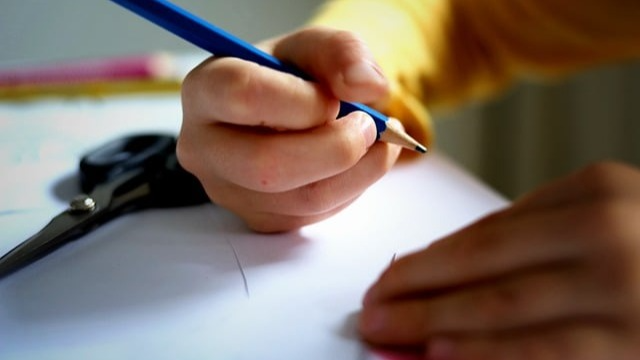 student holding a pencil