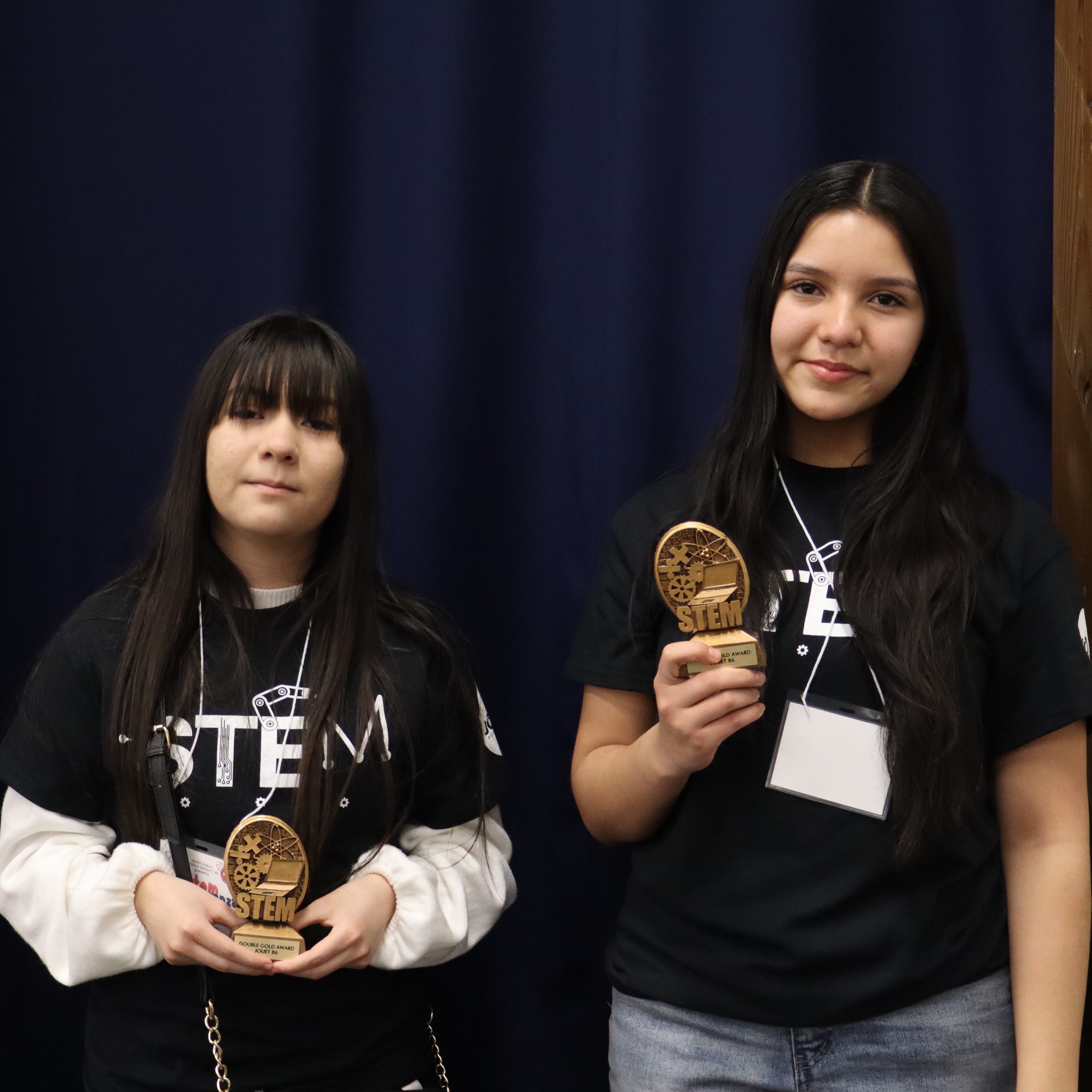 Two students with double gold trophies