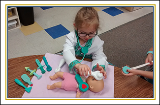 Girl playing with baby toy