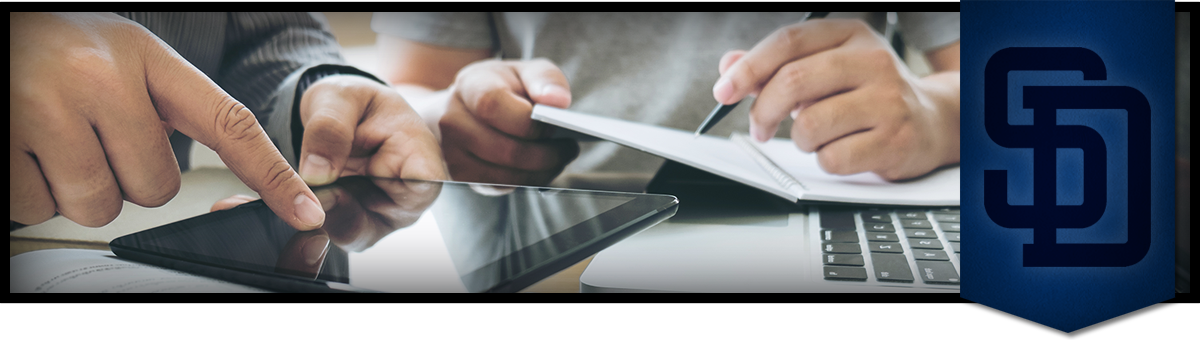 hands working on a tablet  and writing in a notebook