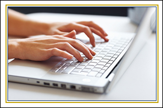 A close up of a person typing on a laptop