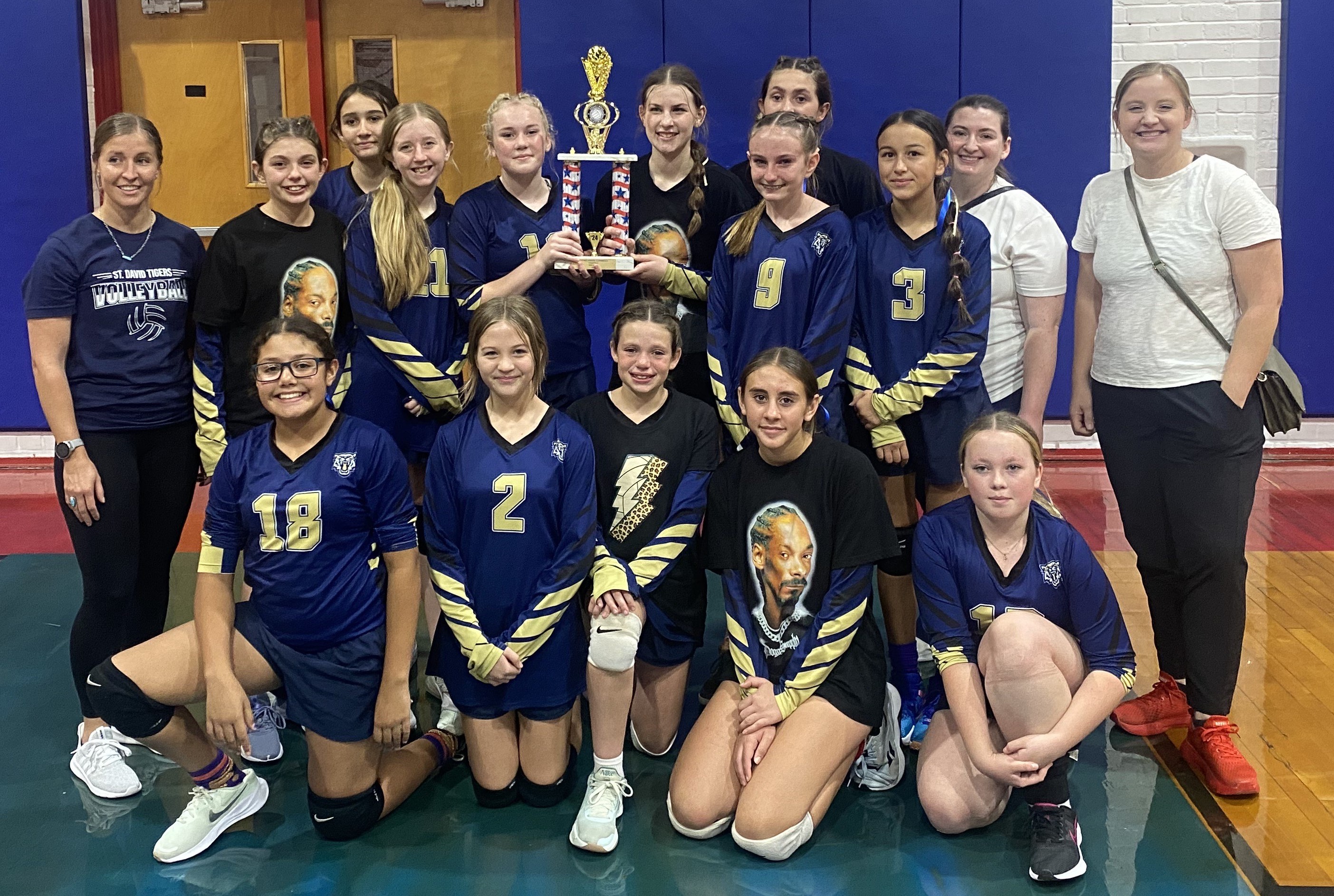 volleyball team holding trophy