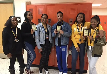 group of students showing a card
