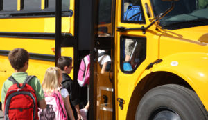 kids getting on bus