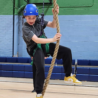 Boy climbing on rope