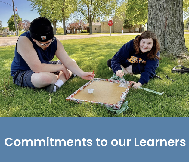 Two learners sitting under a tree painting