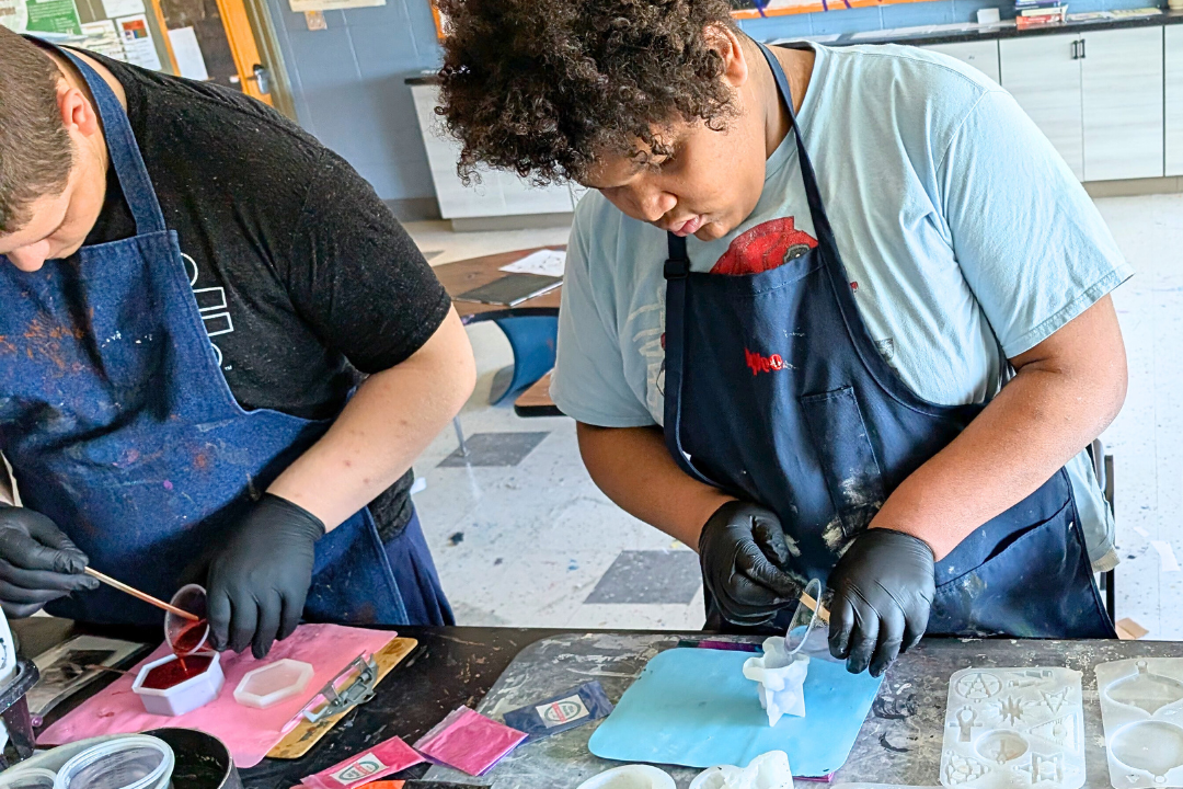 two learners making candles for week of service