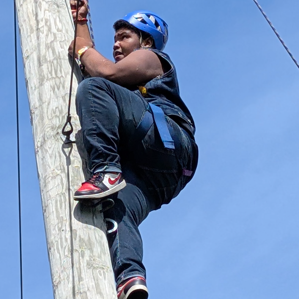 young learner climbing ropes course
