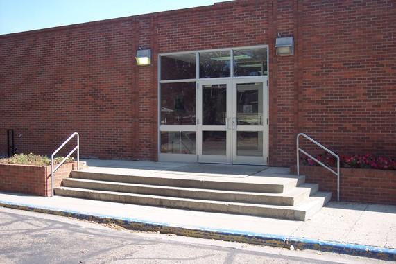 Front entrance of brick building with steps.