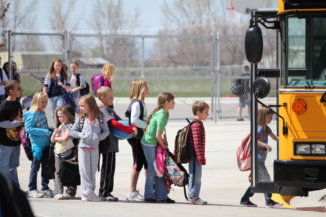 Students in line to get on a school bus