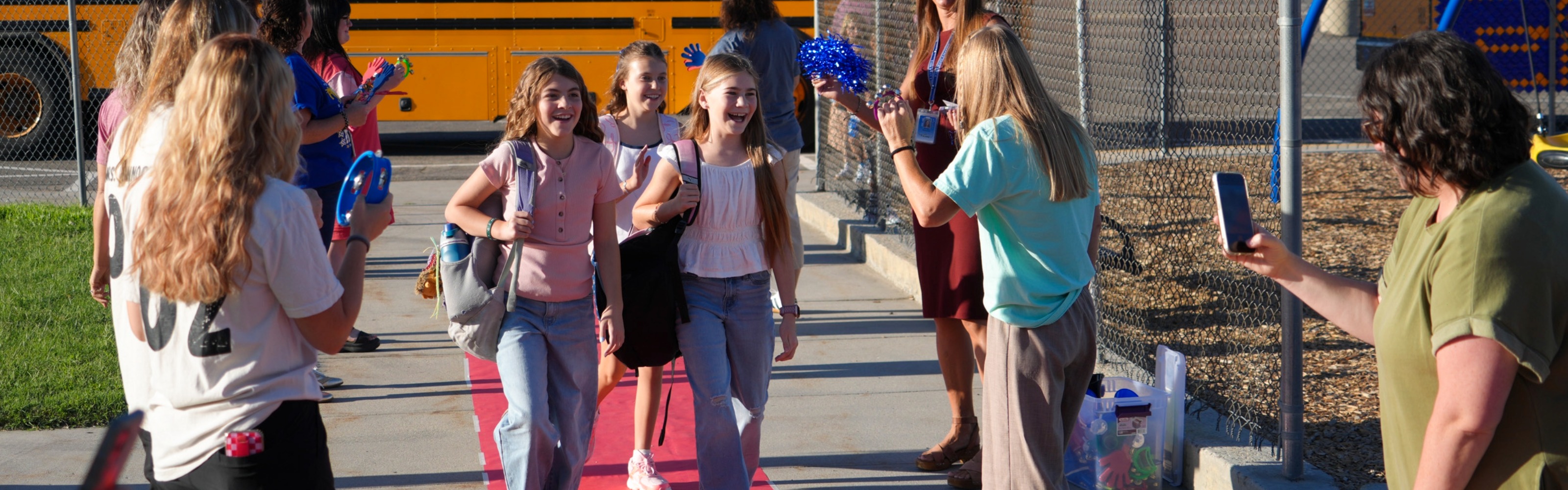 students walking on red carpet on first day of school
