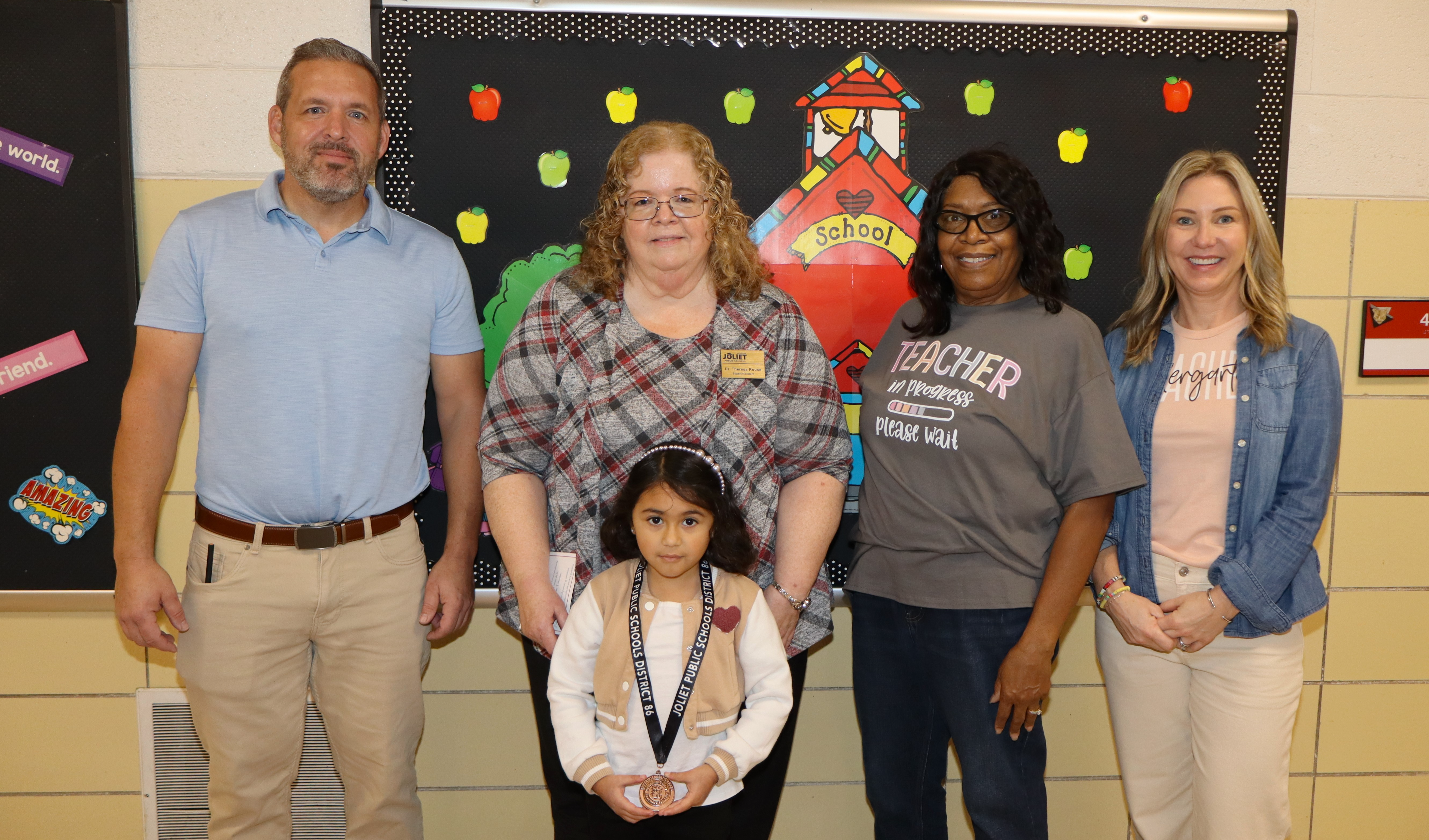 Superintendent, Principal, and teachers with student award winner