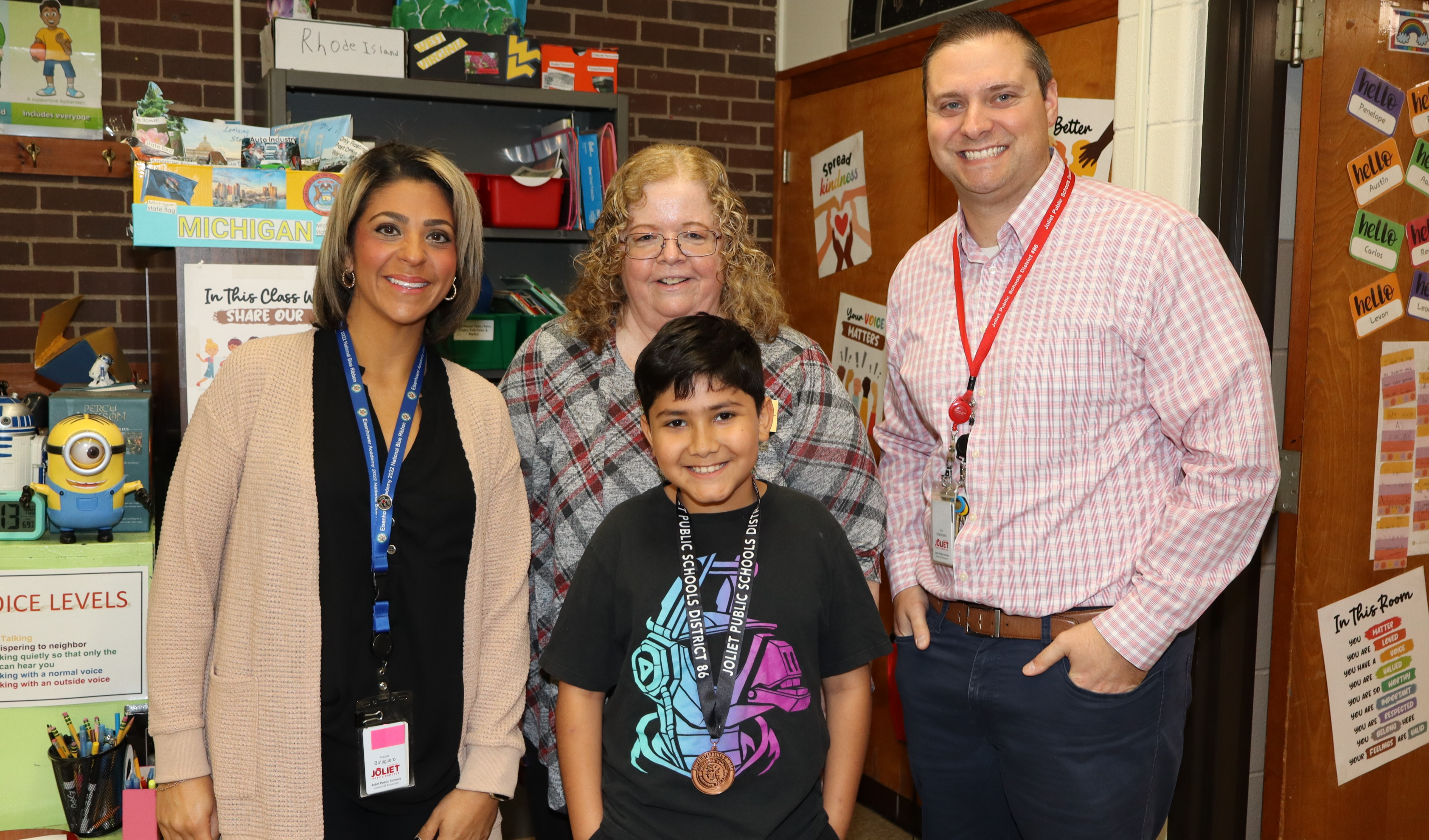 Superintendent, Principal, and assistant principal with student award winner