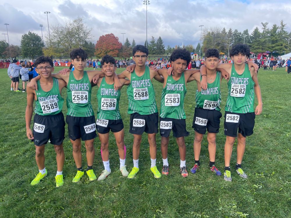 A group of runners posing for a picture before the start of a race.