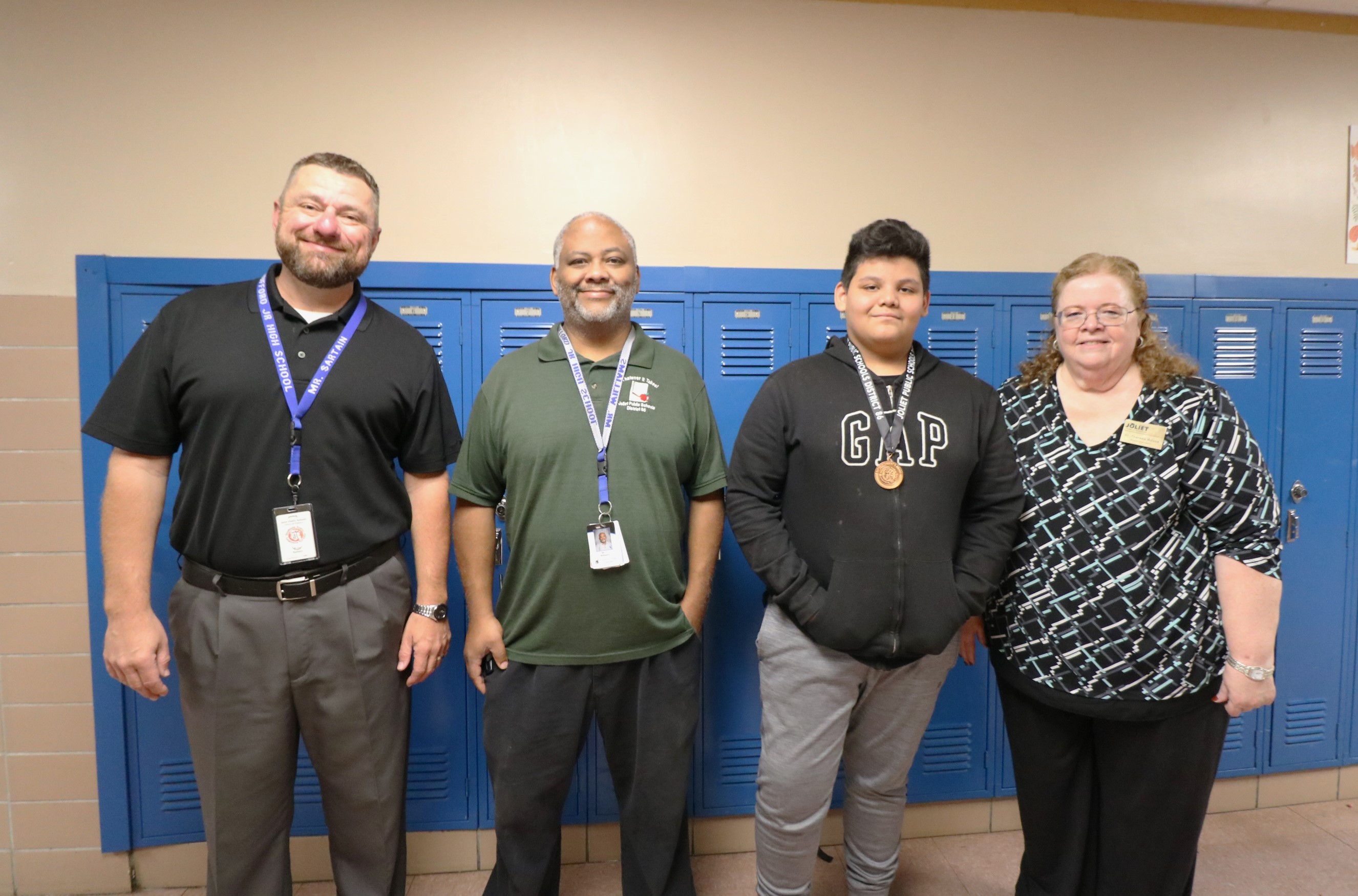 Superintendent, Principal, and academic advisor with student award winner