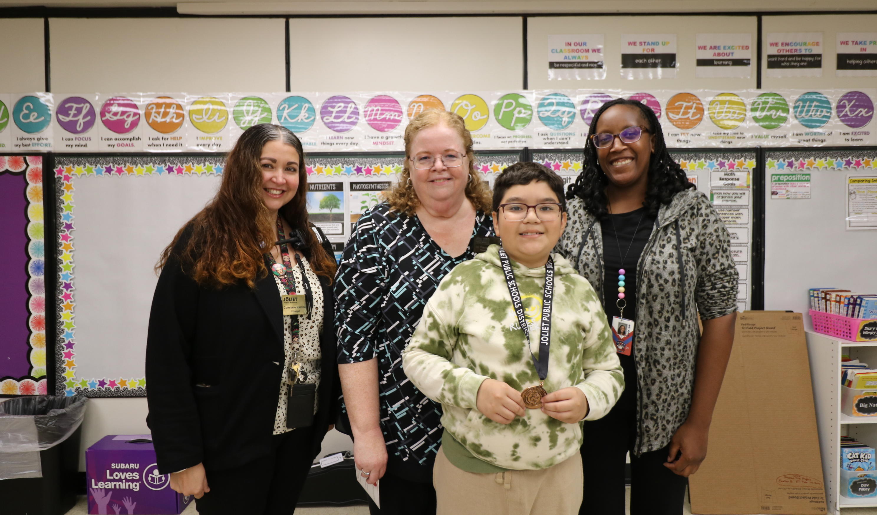 Superintendent, Principal, and teacher with student award winner