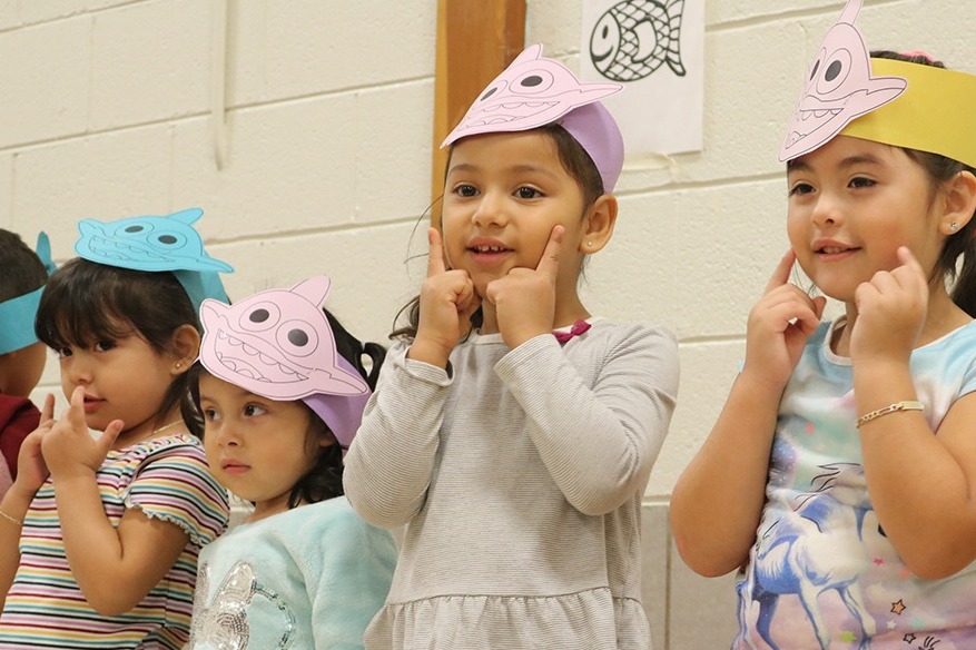 A group of children dressed in paper party hats, ready for a fun celebration.