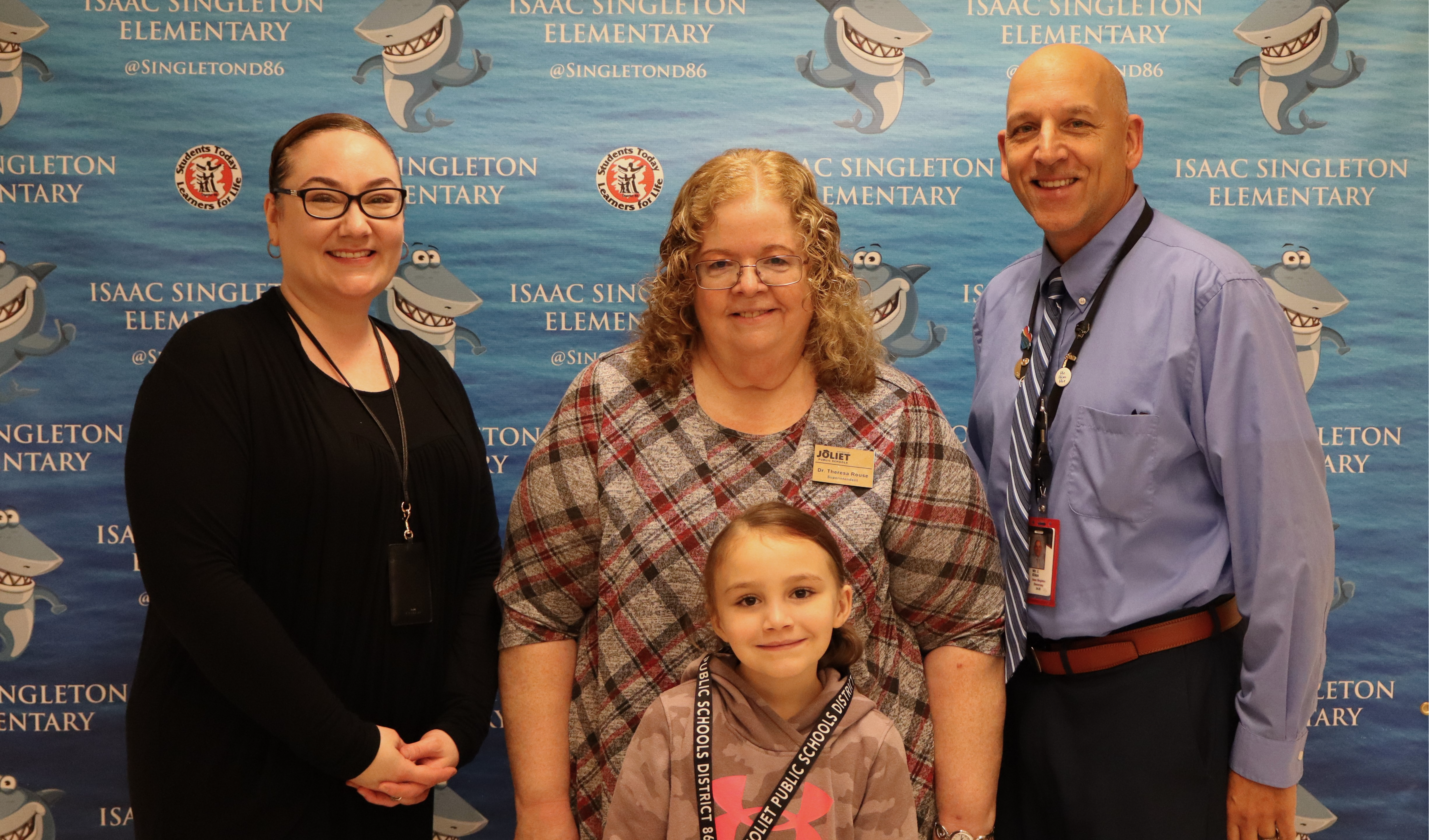 Superintendent, Principal, and teacher with student award winner