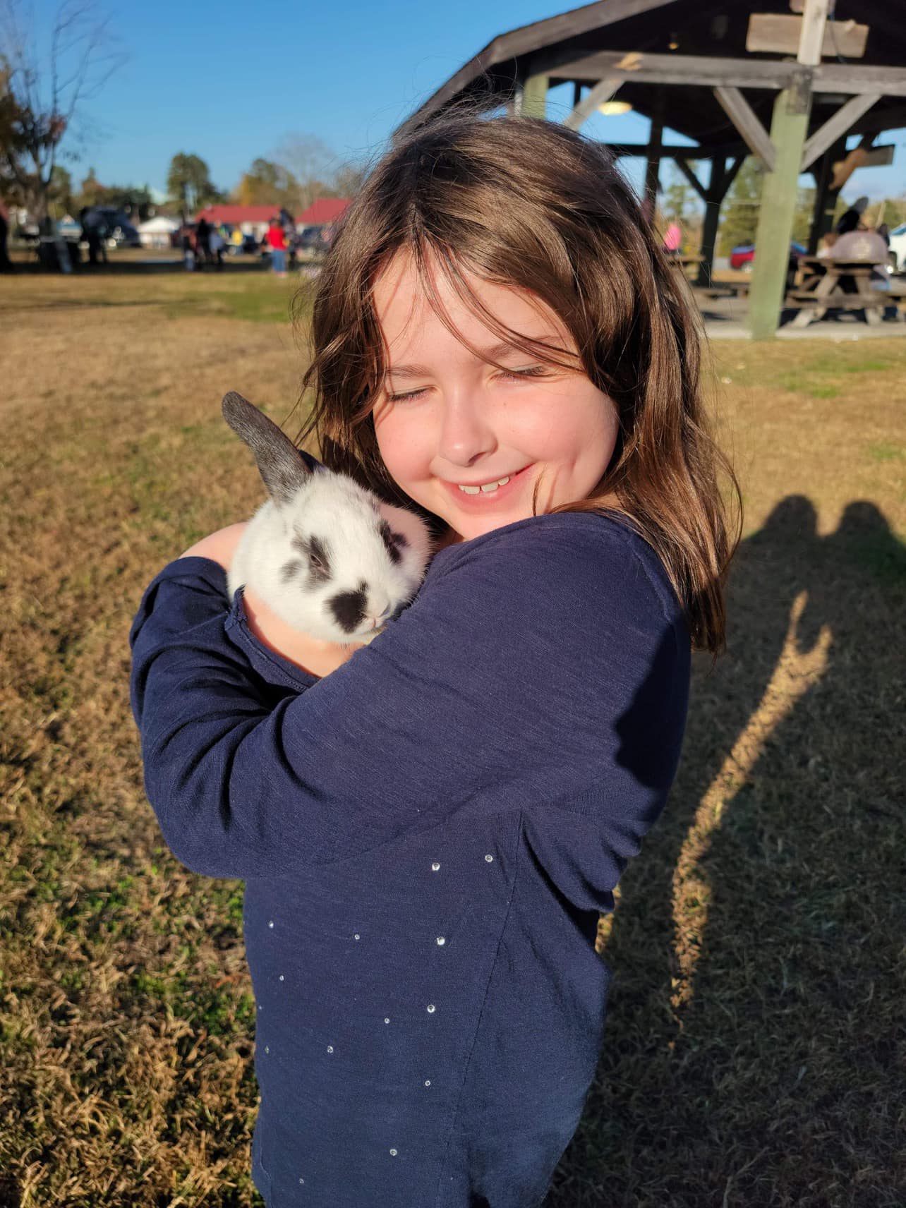 Student smiling with a rabbit