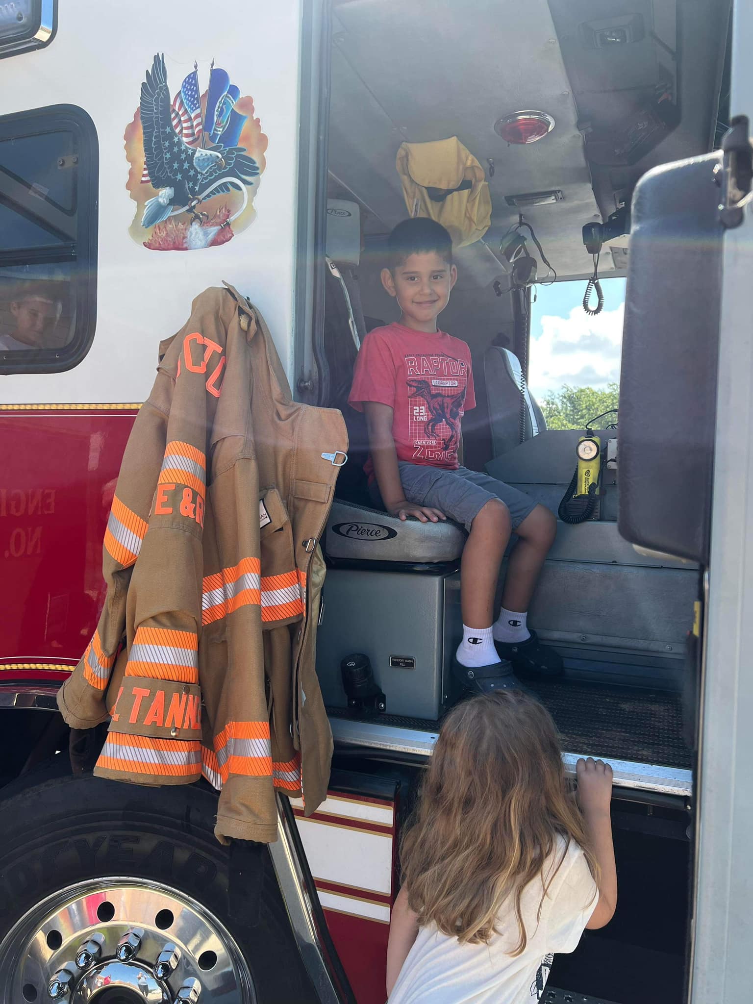 student sitting in a fire truck