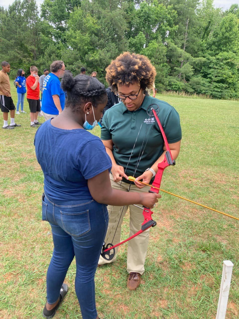 student being taught archery by 4-h