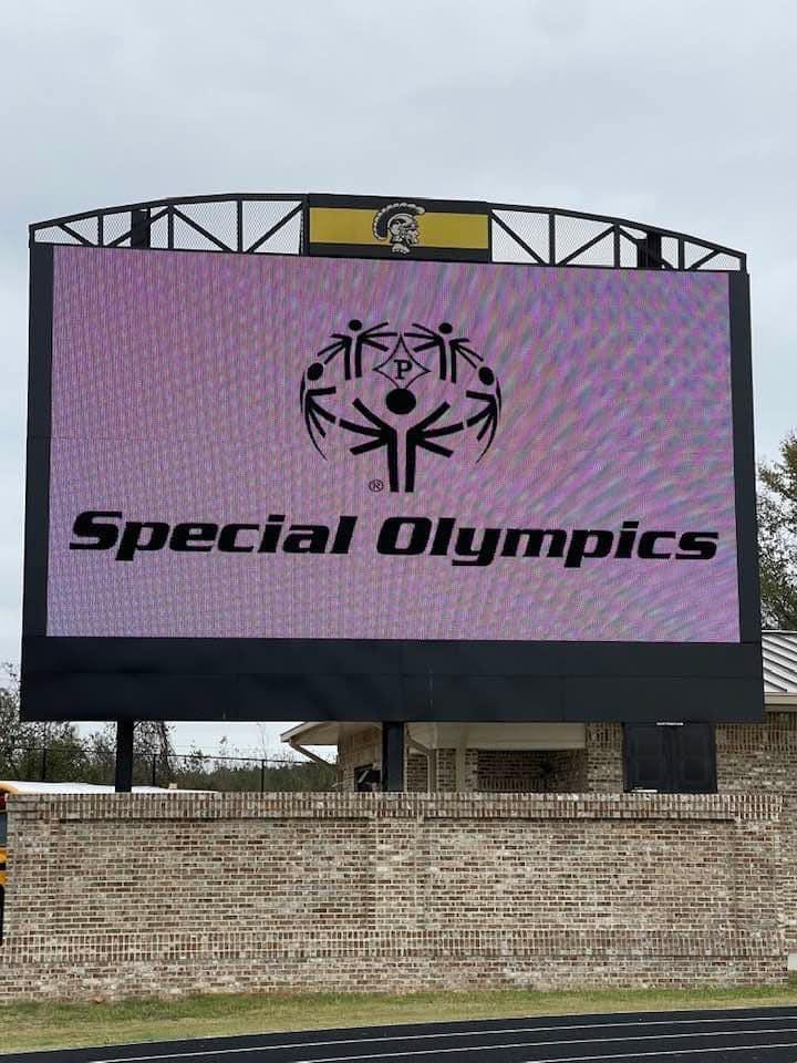 A large screen with the words 'Special Olympics' displayed prominently.