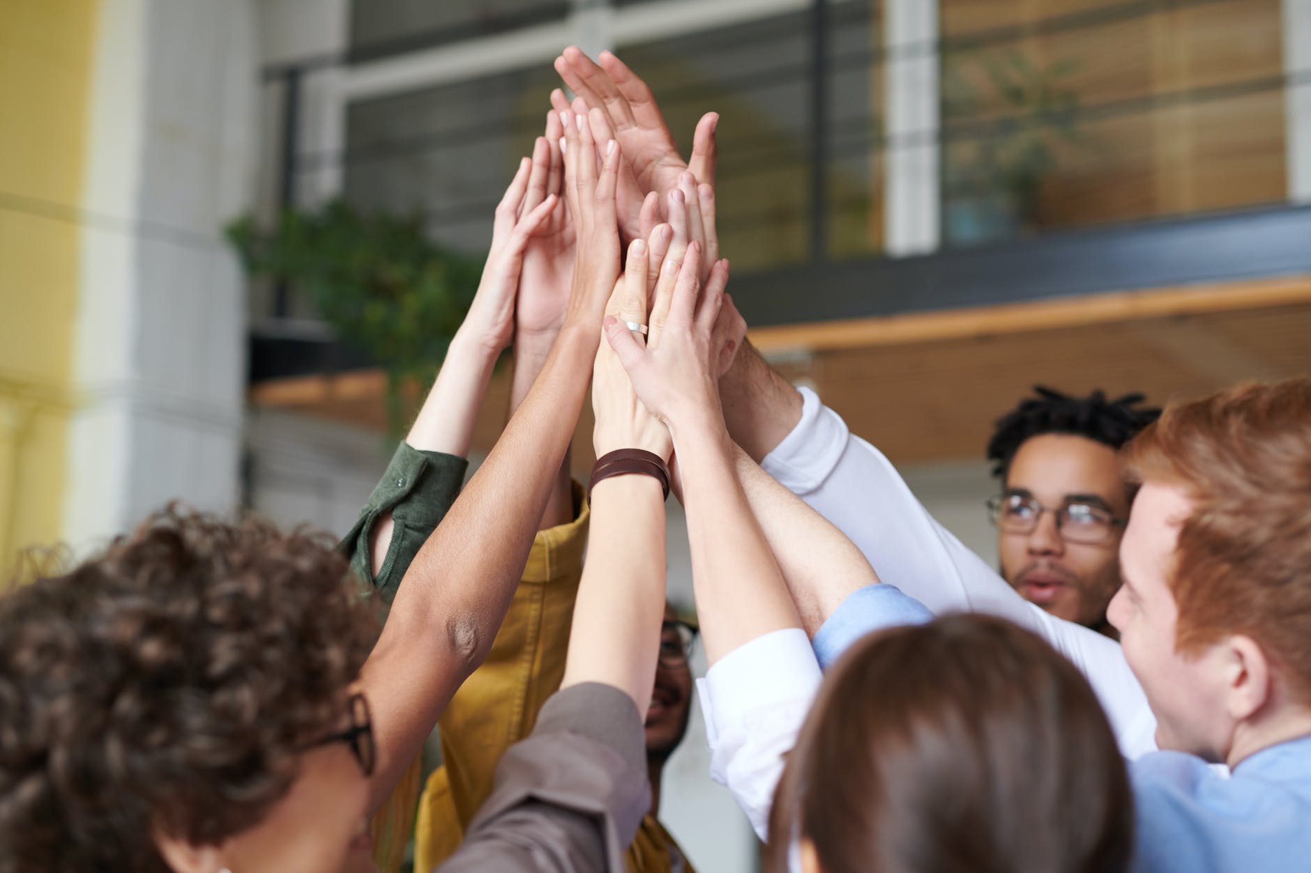 photo of people touching each others hands