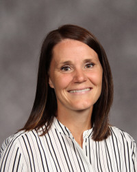 Woman with dark hair Smiling with grey background