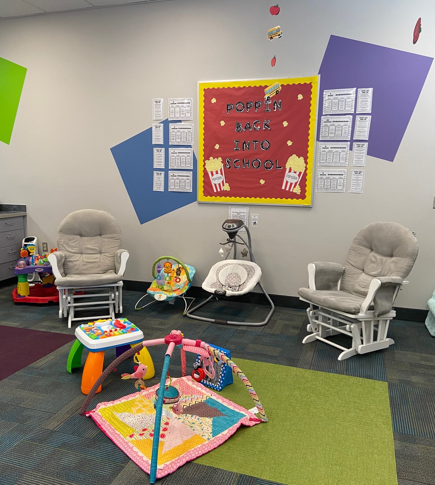 two rocking chairs, two baby swings and baby mat