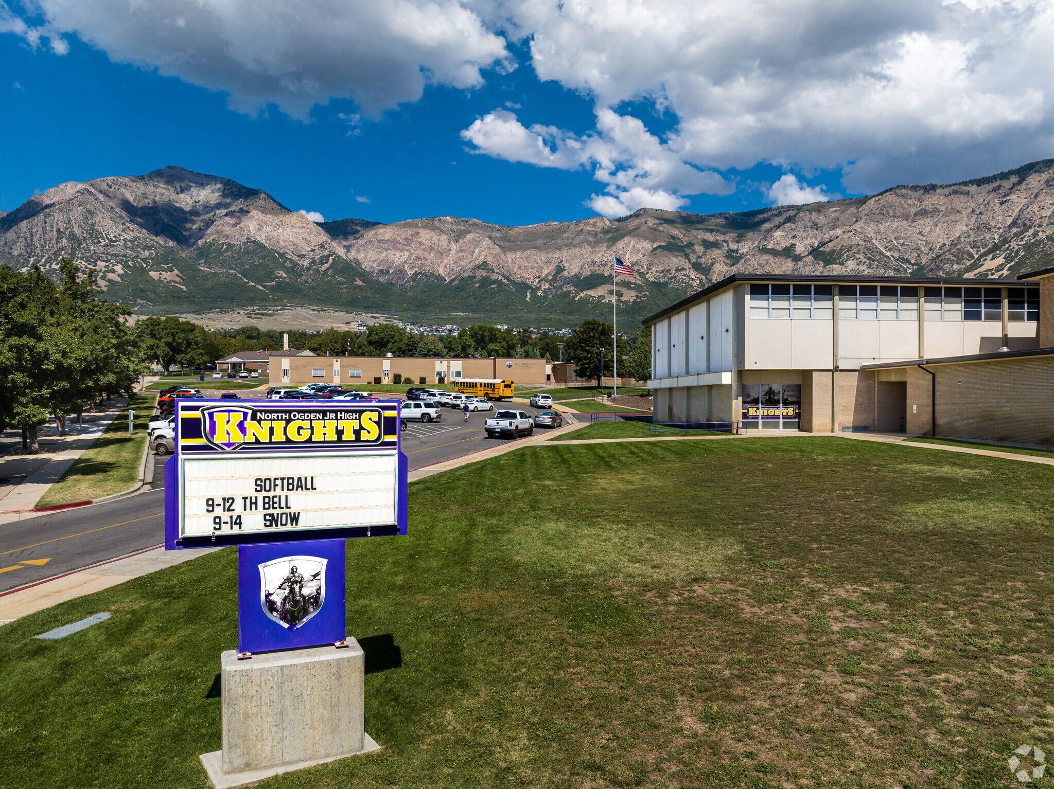 Blue sign with white lettering outside school reading 'Knight's High School'.