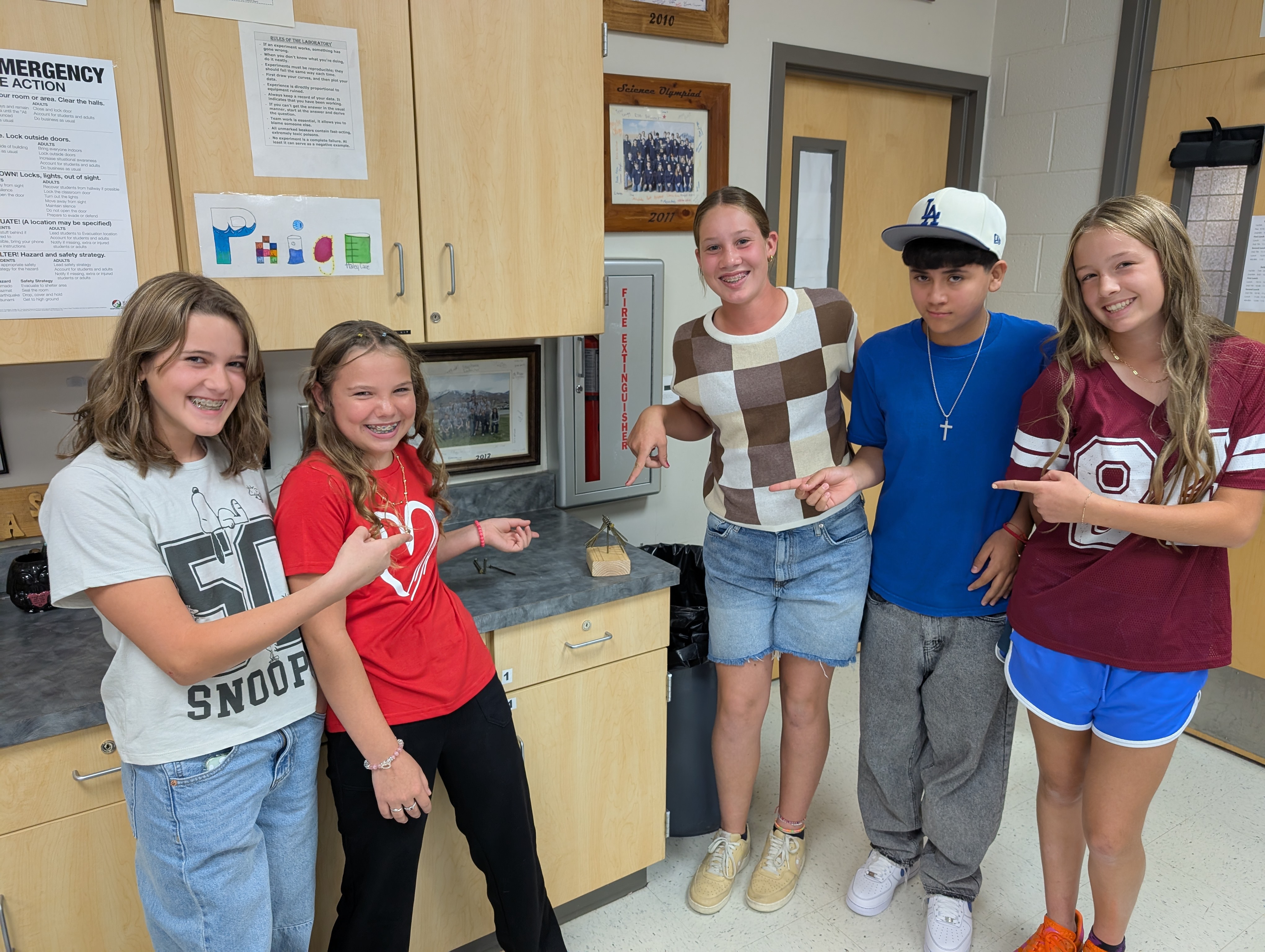 students teambuilding by stacking nails on a nailhead
