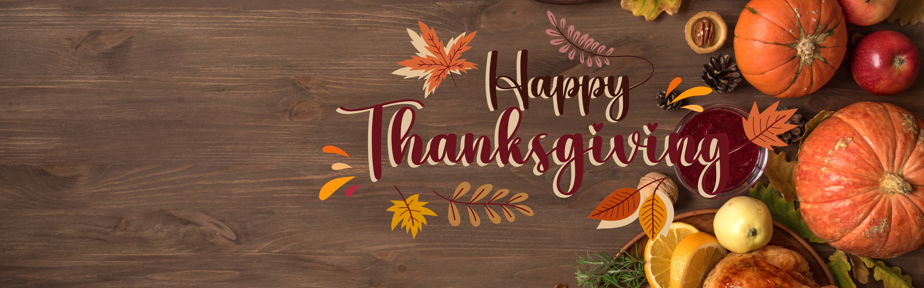 Wood table background with food on the table, with the words Happy Thanksgiving.