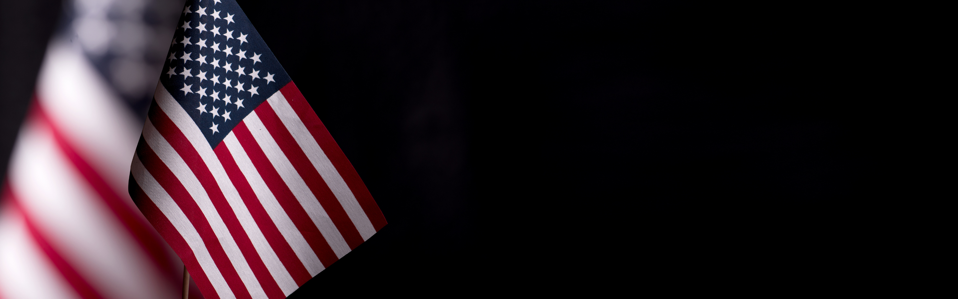 An American flag on the left with a black colored background.