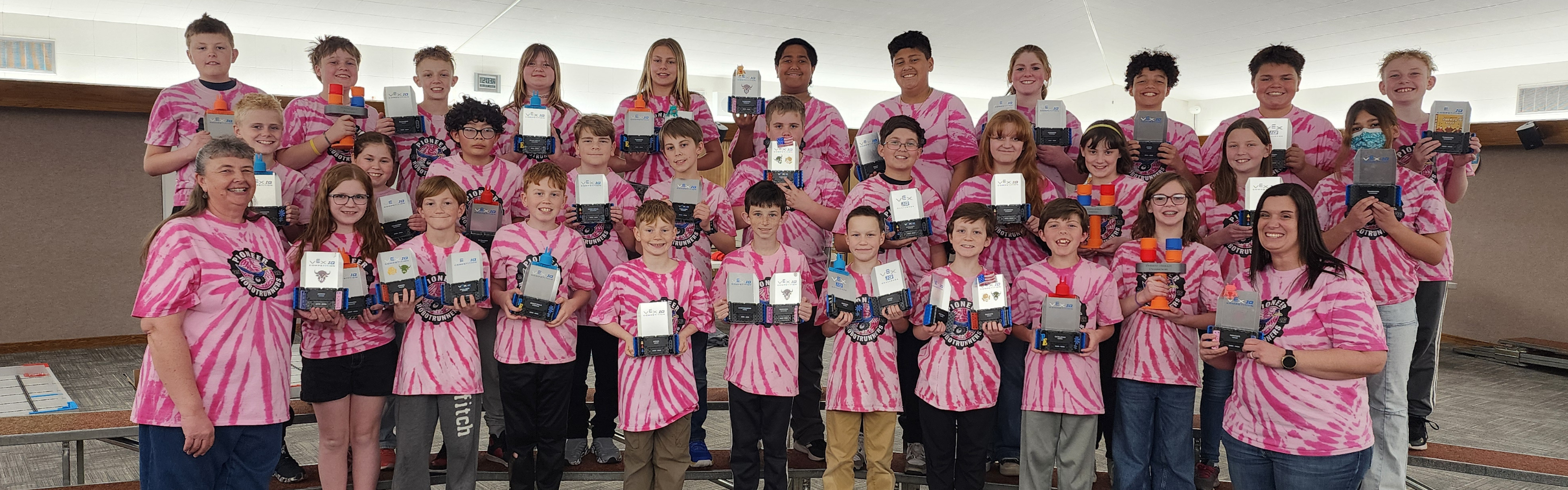 Robotics students posing for camera holding awards