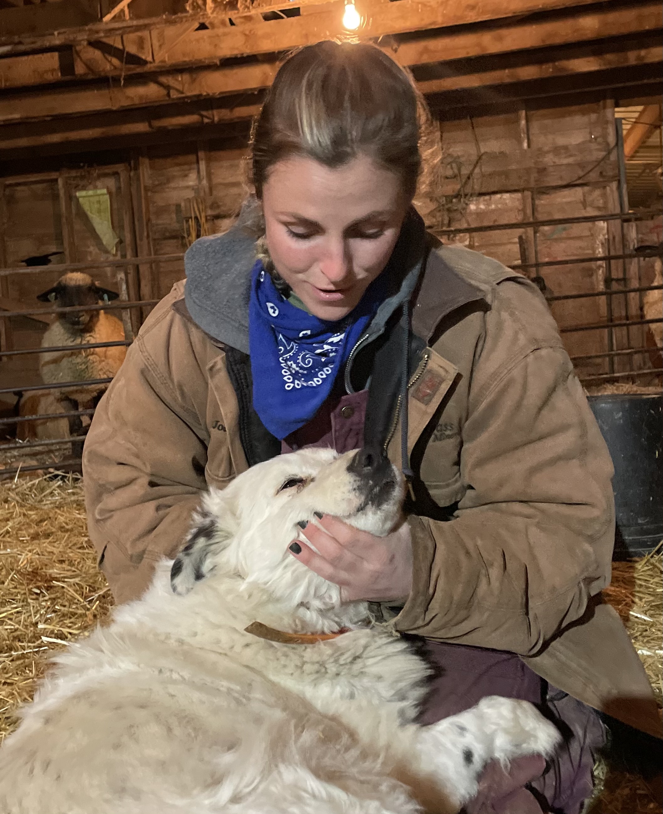 Picture of Miss Bingham in a barn with a dog.