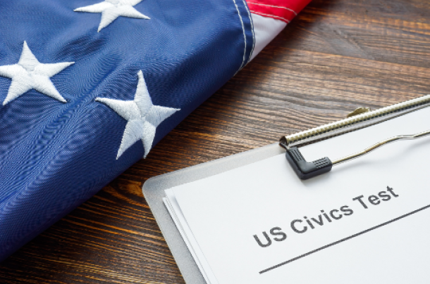 American flag next to a clipboard with a civics test paperwork.