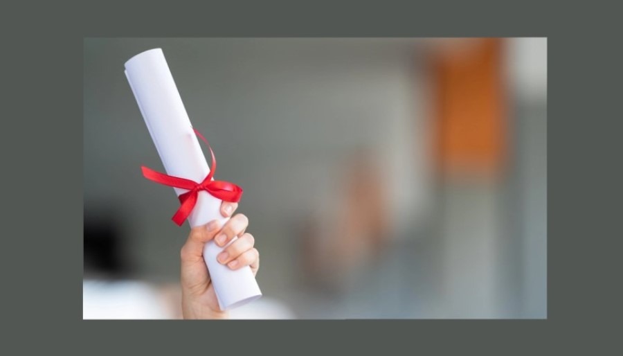 hand holding a diploma 